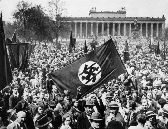 Photo of Iron Front members marching with defaced swastika flag.