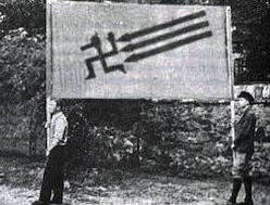 Photo of Iron Front members with a banner depicting a swastika retreating from the three arrows.